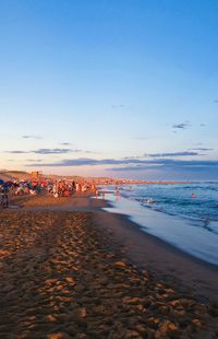 Scenic view of beach against sky during sunset