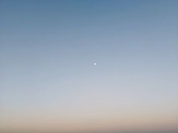 Low angle view of moon against clear sky at dusk