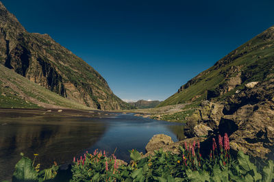 Scenic view of lake and mountains against sky