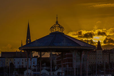 Traditional building against sky during sunset