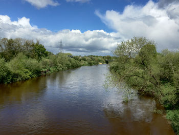 Scenic view of lake against cloudy sky