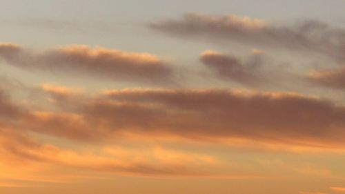 Low angle view of cloudy sky at sunset