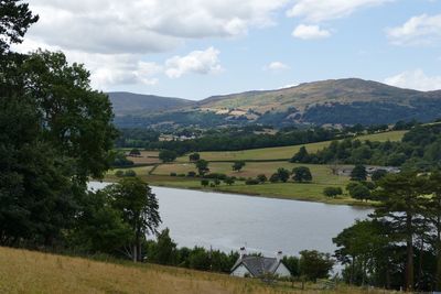 Scenic view of lake and mountains against sky