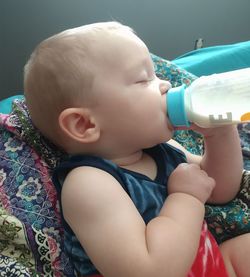 Cute baby boy drinking milk