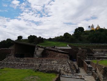 Old building on field against sky