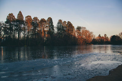 Scenic view of lake against sky at sunset