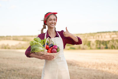 Young woman smiling while standing on field