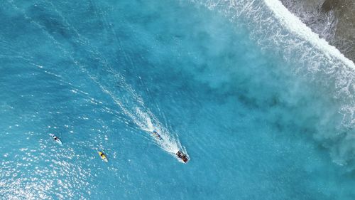 High angle view of people swimming in sea