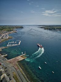 High angle view of boats on sea shore against sky