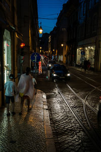 Vehicles on city street at night