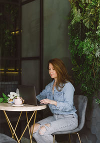 Young woman using laptop at home