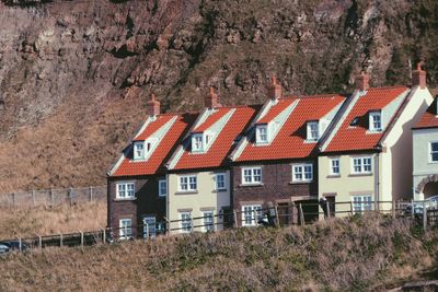 Row houses against rock formation