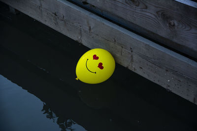 High angle view of yellow balloon in water