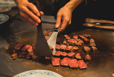 Midsection of person preparing food in kitchen