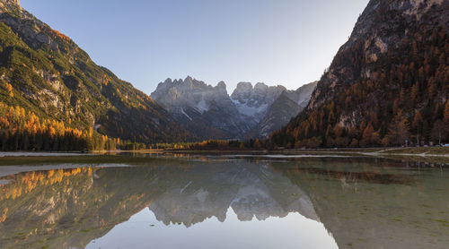 Scenic view of lake and mountains against clear sky in dolomites mountains 