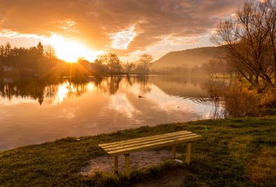 Scenic view of lake against sky during sunset