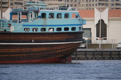 Boats moored in sea against buildings