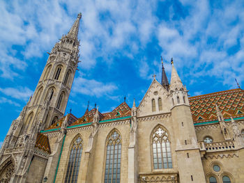 Low angle view of building against cloudy sky