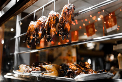 Close-up of meat hanging in kitchen at restaurant