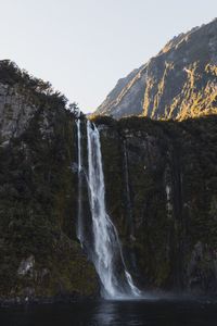 Scenic view of waterfall against clear sky