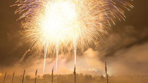 Low angle view of firework display at night