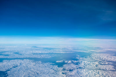 Beautiful blue cloudy sky on the top of the plane while traveling pass by.