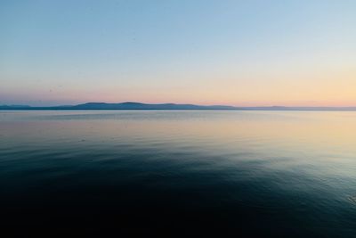Scenic view of sea against clear sky during sunset
