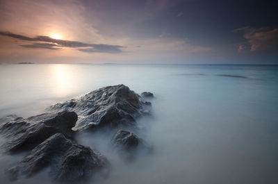 Scenic view of sea against sky at sunset