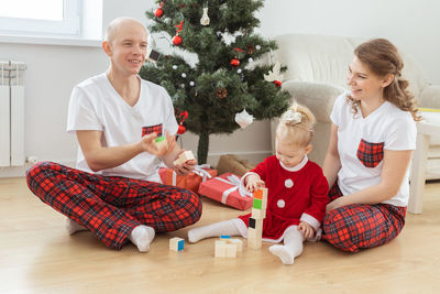 Couple with daughter at home during christmas