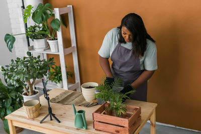 Portrait of young man gardening at home