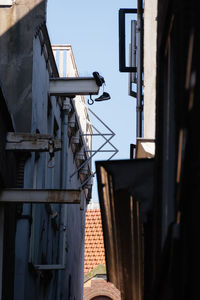 Low angle view of shoes on metal mounted on building