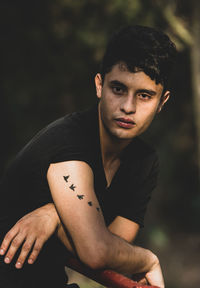 Portrait of young man sitting outdoors