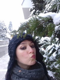 Portrait of man against snow covered trees