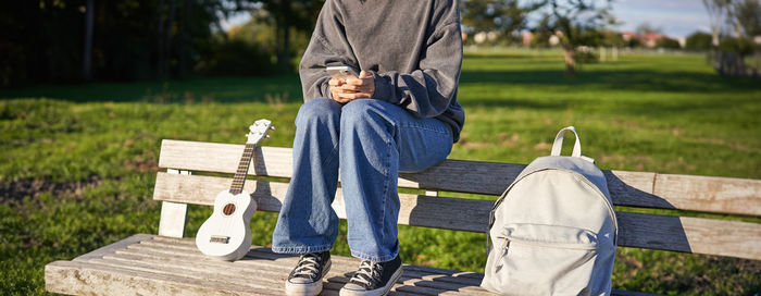 Low section of woman sitting on bench