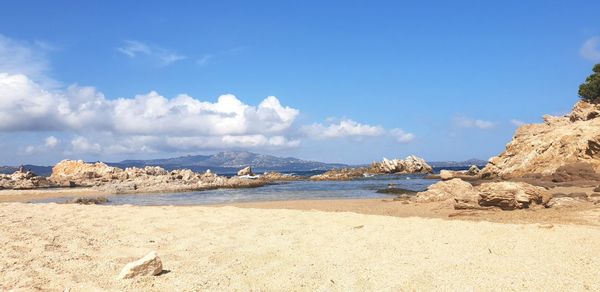 Panoramic view of beach against blue sky