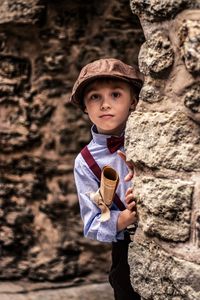 Portrait of boy standing on rock