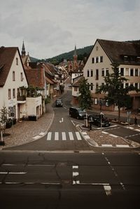 Road amidst buildings against sky