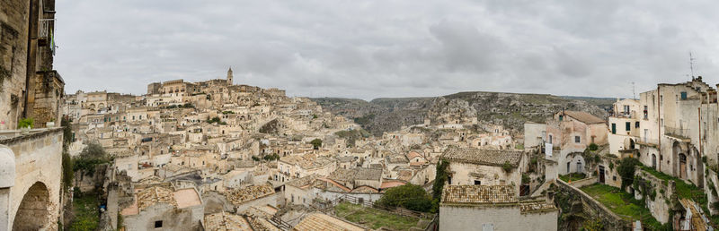 Panoramic view of buildings in town against sky