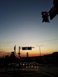 Low angle view of traffic on road at sunset