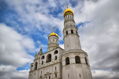 Low angle view of building against cloudy sky