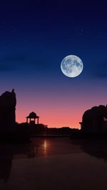 Scenic view of lake against sky at night