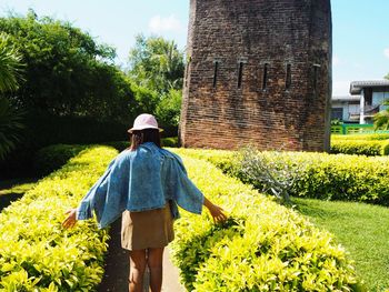 Rear view of person wearing hat on field