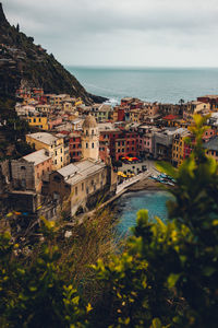 High angle view of townscape by sea against sky