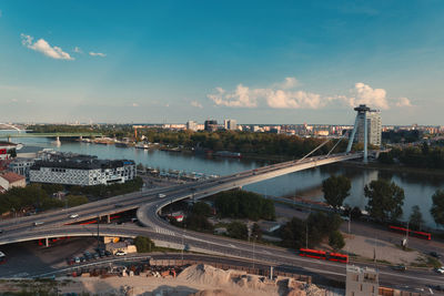 High angle view of illuminated bridge over river against sky at sunset