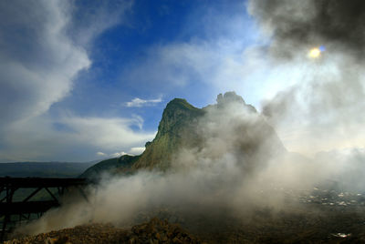 Scenic view of waterfall against sky