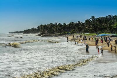 People standing on shore at beach