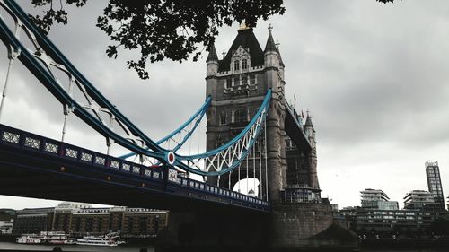 Low angle view of suspension bridge in city