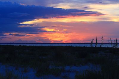 Scenic view of sea against romantic sky at sunset