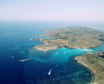 Aerial view of sea against clear sky