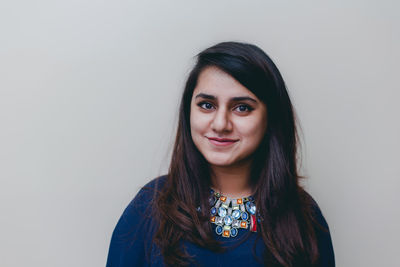 Portrait of woman against white background